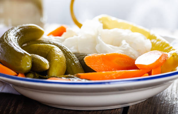 istock Assorted pickled vegetables in bowl/plate on natural wooden background. 1270605385