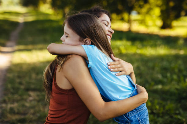 istock Mother and daughter sharing love while hugging in the park 1270606840