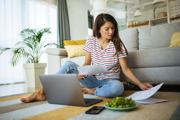 istock Mid adult woman working from home using laptop 1270606856