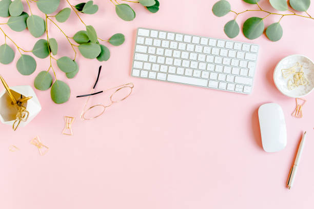 istock Office table desk with computer, green leaves eucalyptus, clipboard, golden accessories, diary, glasses. Magazines, social media. Top view. Flat lay 1270607143