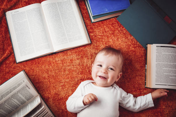 istock One year old baby among the books. 1270608088