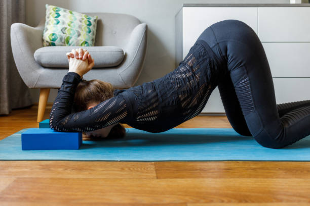 istock Slim girl stretching her body on home yoga routine 1270609471