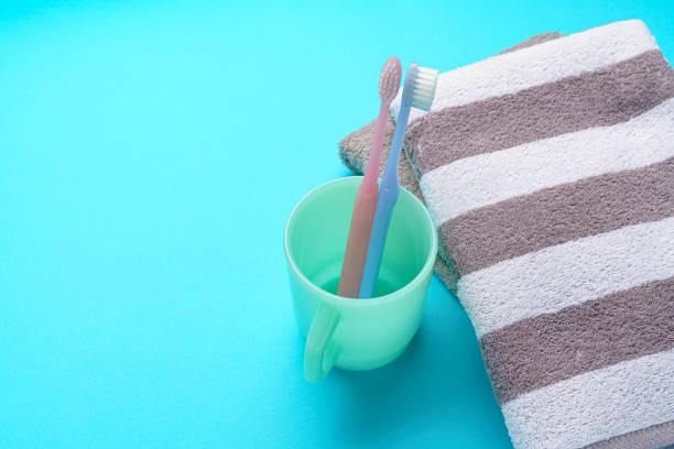 The toothbrushes, cup and towel The toothbrushes, cup and towel bad breath couple stock pictures, royalty-free photos & images