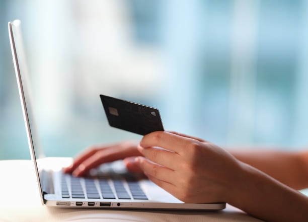 istock credit card payment in front of laptop 1270611100