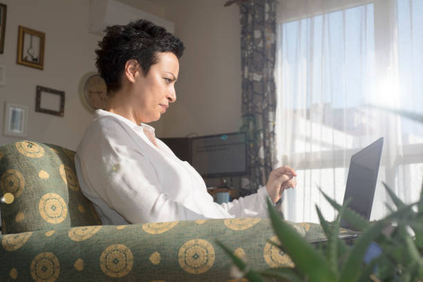 istock Woman using laptop and working from home 1270611600