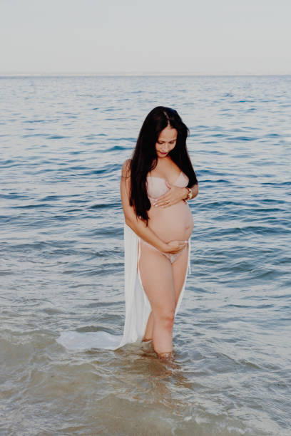 istock Pregnant mother on the seashore 1270614127