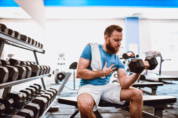istock Male Bodybuilder Doing Bicep Curls With Dumbbell In Gym 1270614157