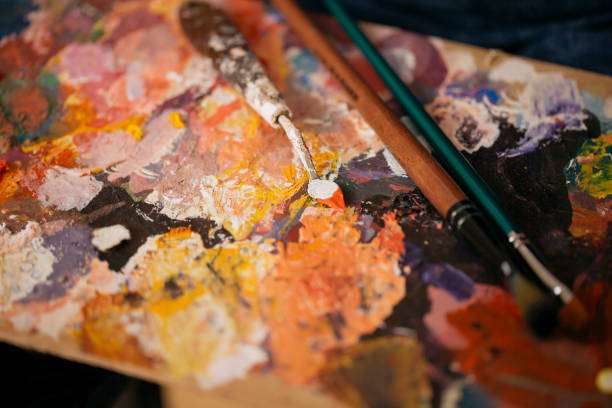istock Close up of painting spatula covered with paint. 1270614376