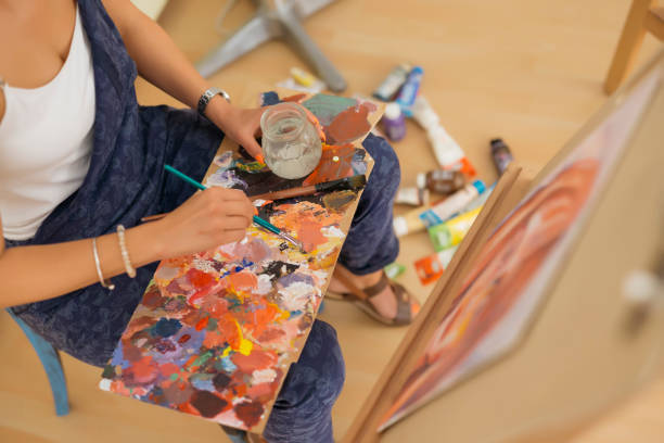 istock Close up of hand holding paint brush. 1270614446