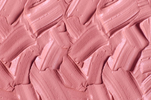 istock Pale pink cosmetic clay (alginate facial mask, face cream, body wrap) texture close up, selective focus. Abstract background with brush strokes. 1270614591