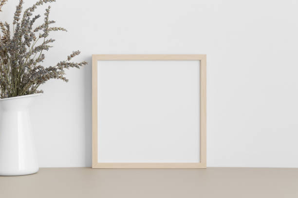 istock Square wooden frame mockup with a lavender in a vase on a beige table. 1270614678
