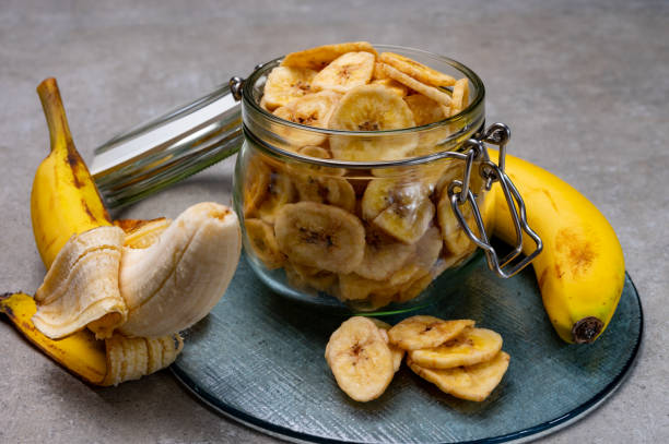 istock Healthy snack, crispy dehydrated unsugared banana chips in glass jar 1270615882