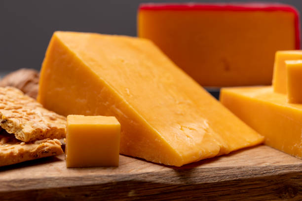 istock Red waxed yellow cheddar cheese and crackers with grated cheese 1270616030