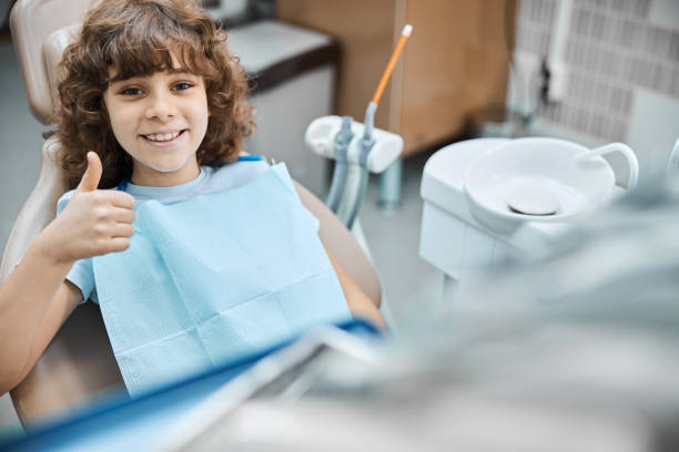 istock Cute curly child smiling ready for dental check-up 1270617135