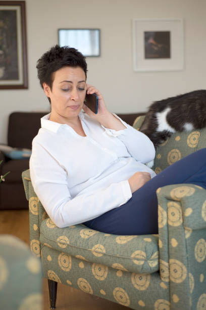 istock Middle aged woman talking on mobile at home 1270617973