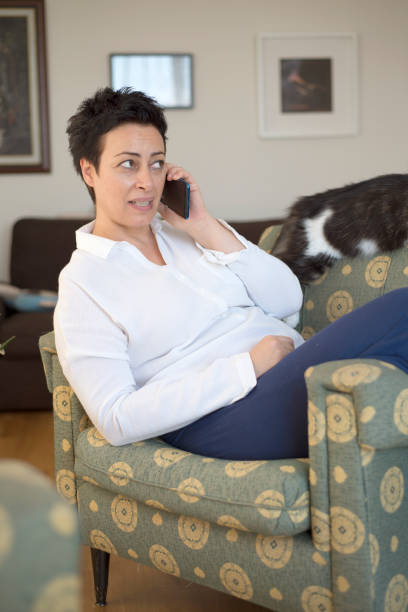 istock Middle aged woman talking on mobile at home 1270618110
