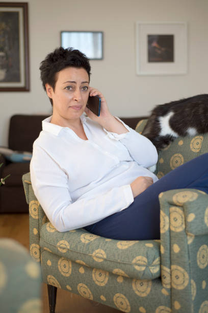 istock Middle aged woman talking on mobile at home 1270618178