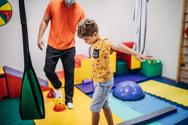 istock Boy exercising with physical therapist in sensory room 1270618473