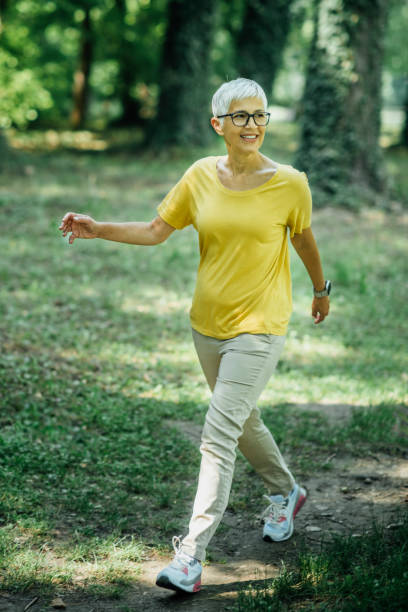istock Senior Woman Enjoying Walking Exercise in Nature 1270618526