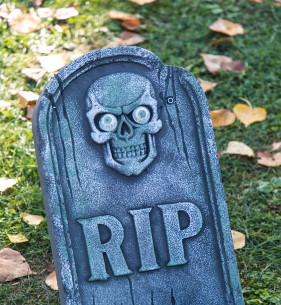 istock tombstone with skull and RIP sign 1270620475
