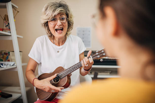 istock Young student playing and singing with music teacher in child development center 1270620670