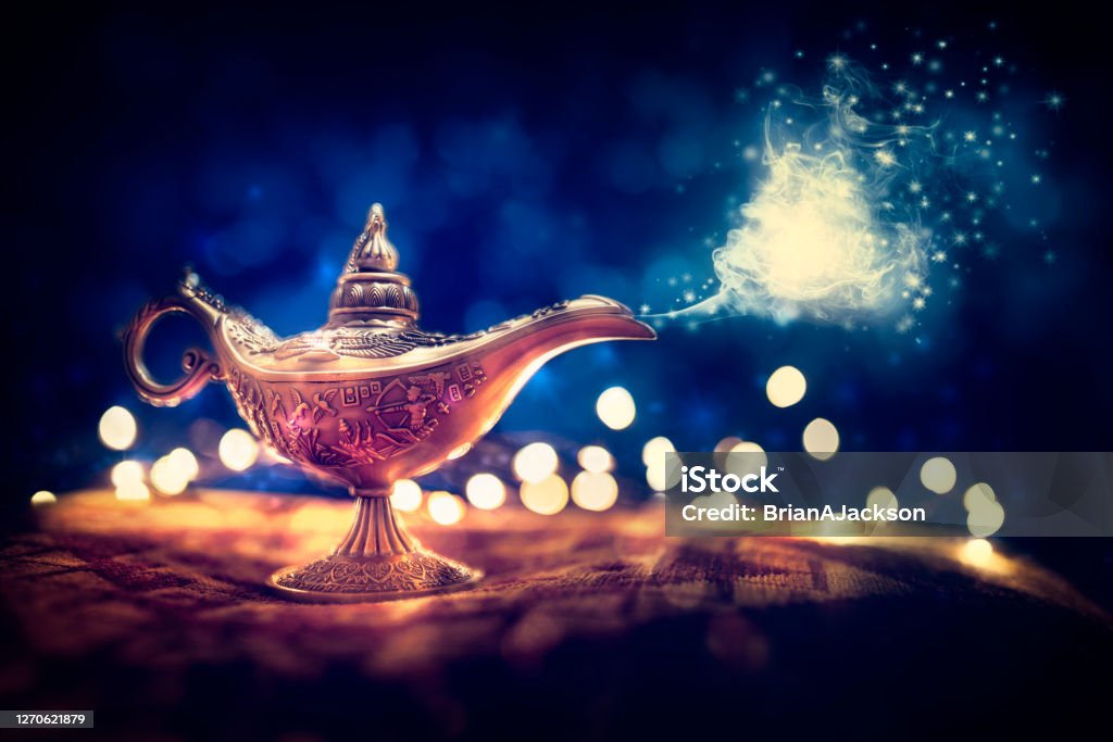 Magic Aladdins Genie lamp Magic lamp from the story of Aladdin with Genie appearing in blue smoke concept for wishing, luck and magic One Thousand and One Nights Stock Photo
