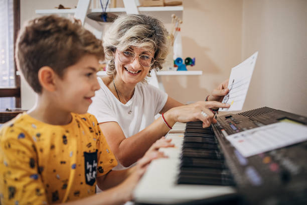 istock Preschool kid learning how to play synthesizer in child development center 1270623684