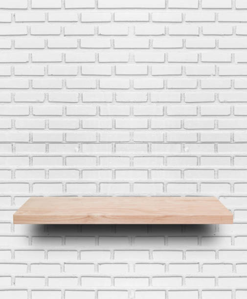 istock Empty wooden shelf on white brick wall background. 1270624014