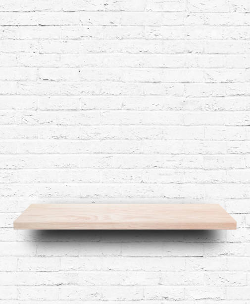 istock Empty wooden shelf on white brick wall background. 1270624833