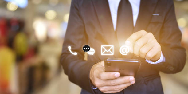 istock CONTACT US, Businessman hand holding mobile smartphone with icon (mail, address, call) 1270624890