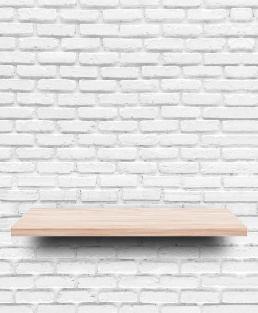istock Empty wooden shelf on white brick wall background. 1270625075