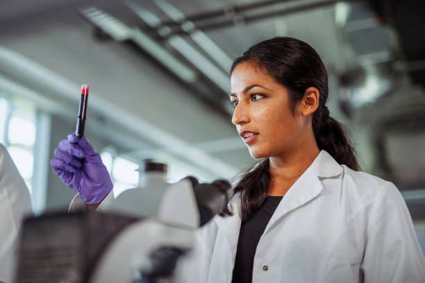 istock Indian University Student Holding Test Tube in Laboratory 1270625158