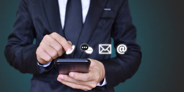 istock CONTACT US, Businessman hand holding mobile smartphone with icon (mail, address, call) 1270625219