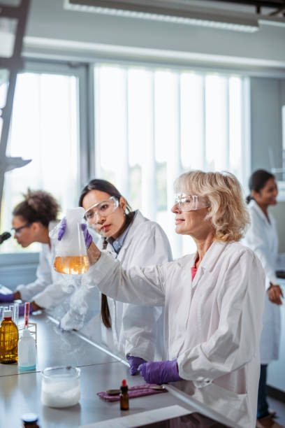 istock Asian Student Watching Professor Create Chemical Reaction 1270625320
