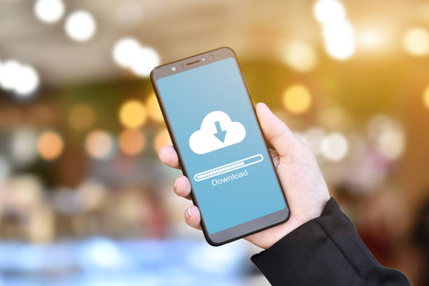 istock Businessman hand using mobile phone with cloud download form stored data. 1270628693