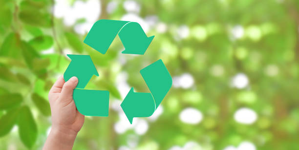 istock Hand holding logo recycling over green bokeh background 1270628723