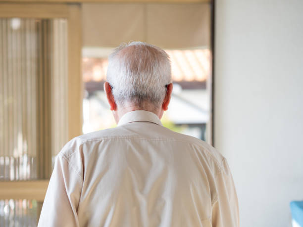 istock An old man walking away into a bright doorway 1270630206