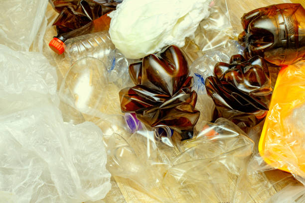 istock Lot of used plastic, crumpled empty bottles, packets, plastic orange dish, diaper, pollution recycle eco concept background close up selective focus 1270631448