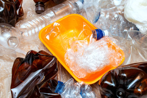 istock Lot of used plastic, orange container plate, crumpled empty bottles, packets, pollution recycle eco concept background close up selective focus 1270631458