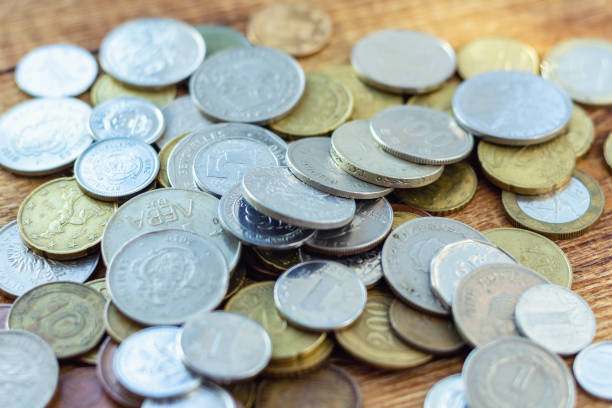 istock coins old rusty brass euro Seychelles Bulgaria China Germany pile pack heap stack on a wooden background finance economy investment savings concept mock up selective focus close up 1270631728
