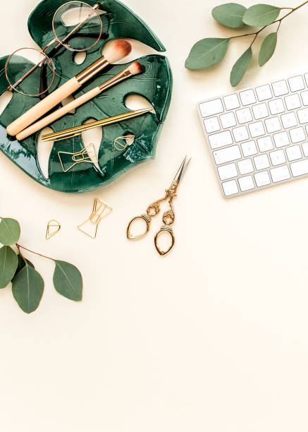 istock Flat lay home office desk. Female workspace with computer, plate sheet monstera, golden accessories, eucalyptus leaves, on beige background. Top view 1270632673