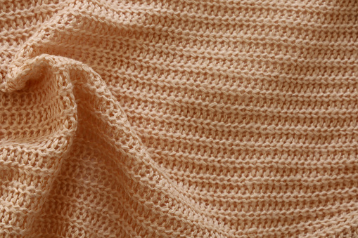Trend russet woolen knitted background, texture, close-up