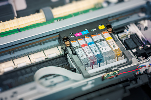 Replacement of CMYK set of ink cartridges in printer.
