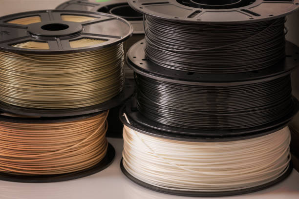 Many spools of 3D printer plastic filaments. Many spools of 3D printer plastic filaments. light bulb filament photos stock pictures, royalty-free photos & images
