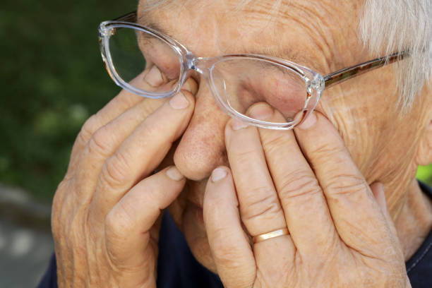 Senior caucasian woman rubbing her eyes under eyeglasses Senior caucasian woman rubbing her eyes under eyeglasses human eye scratching allergy rubbing stock pictures, royalty-free photos & images