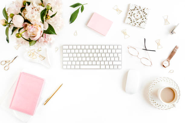 istock Flat lay women's office desk. Female workspace with computer, pink peonies bouquet, accessories on white background. Top view feminine background 1270633109