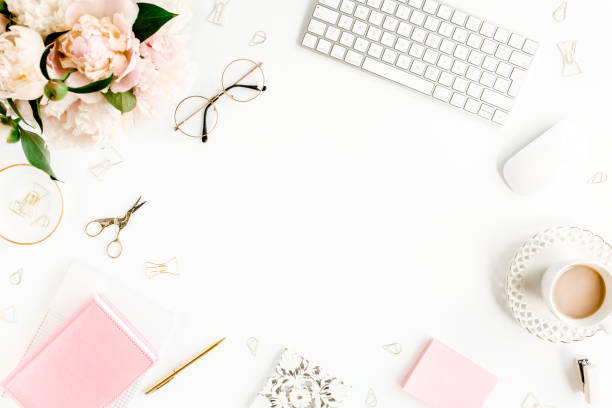 istock Flat lay women's office desk. Female workspace with computer, pink peonies bouquet, accessories on white background. Top view feminine background 1270634119