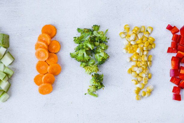 istock Chopped vegetables on the white background, carrot, broccoli, corn and bell pepper 1270634212