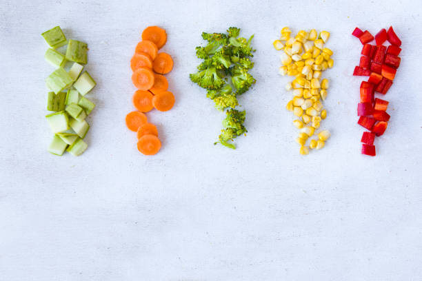 istock Chopped vegetables on the white background, carrot, broccoli, corn and bell pepper 1270634217