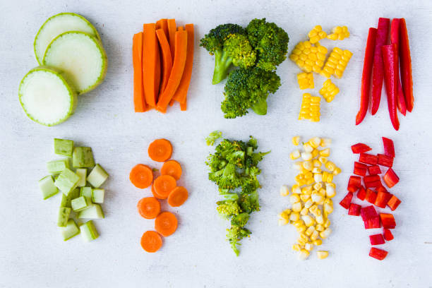 istock Chopped vegetables on the white background, carrot, broccoli, corn and bell pepper 1270634247